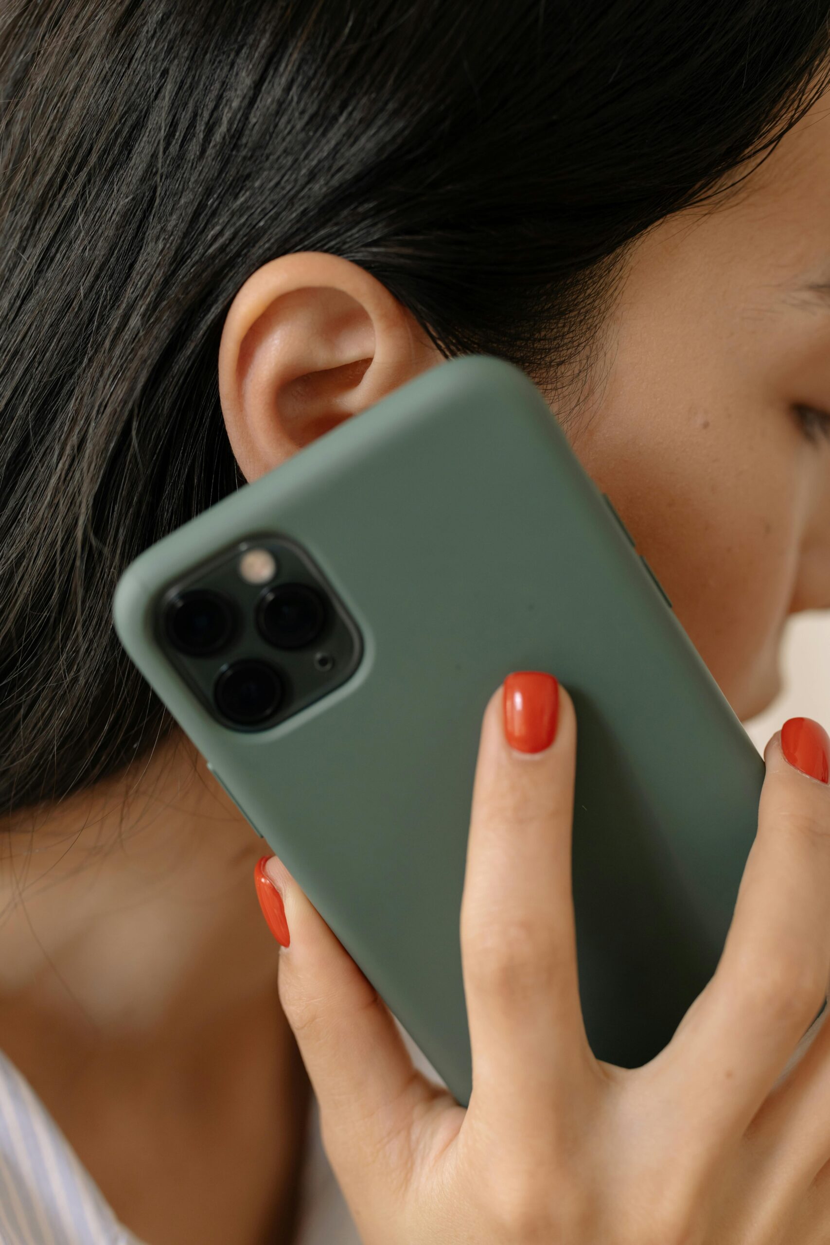 A woman holding a phone to her ear.